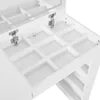 Close-up view of the interior compartments of a white vanity table. Voir les images du produit