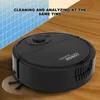 A black robot vacuum cleaner is shown on a wooden floor, with a blue grid pattern in the background. Náhled obrázku produktu