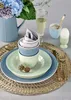 A table setting with a pitcher of hydrangeas, champagne, and tableware. Produktbild-Vorschau