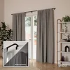 A room with gray curtains hanging over a glass door, with a plant and a shelf with decor in the background. Podgląd zdjęcia produktu