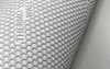A close-up of a rolled-up material with a hexagonal pattern and text. Podgląd zdjęcia produktu