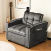 A dark gray sofa bed with a phone holder and cup holders is shown in a room with a guitar and artwork in the background. Produktbild-Vorschau