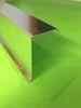 A metallic corner piece is placed on a bright green surface. Produktbild-Vorschau