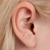 Close-up of a person's ear with an acupuncture needle patch applied. Produktbild-Vorschau