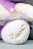 Close-up of a plush toy's foot with embroidered text. Náhled obrázku produktu