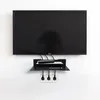 A black wall-mounted shelf holding a set-top box and remote, with power outlets below. Podgląd zdjęcia produktu