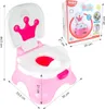 A pink and white baby potty with a crown design, shown next to its packaging. Dimensions are indicated with measurement lines and text. Produktbild-Vorschau
