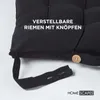 Close-up of a black seat cushion with text overlay and a visible button and strap. Náhled obrázku produktu