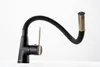 A black kitchen faucet with a flexible hose and gold accents, set against a white background. Produktbild-Vorschau