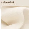 A close-up of beige linen fabric with German text overlay. Produktbild-Vorschau