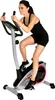 A woman is exercising on a stationary bike. Produktbild-Vorschau