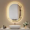A modern bathroom vanity with a sink, faucet, and an illuminated oval mirror. Anteprima dell’immagine prodotto
