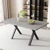 A dining table with a marble-look top and black metal legs, set in a modern dining room with shelves in the background. Produktbild-Vorschau