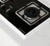 A close-up view of a modern gas stove top with a black glass surface and stainless steel burner grate. Náhľad obrázku produktu
