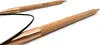 A close-up shot of two circular knitting needles made of wood with copper-colored tips, lying on a white background. Produktbild-Vorschau