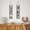 A set of rustic gray collage picture frames hanging on a white wall above a wooden cabinet. Produktbild-Vorschau