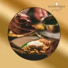 A chef is plating a dish with a spoon, with a logo and text overlay. Produktbild-Vorschau