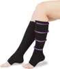 A person's legs wearing black compression stockings. Náhľad obrázku produktu