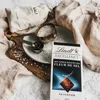 A flat lay composition featuring a bar of Lindt Excellence chocolate with Fleur de Sel, salt in measuring cups and a bag, and a linen cloth. Produktbild-Vorschau