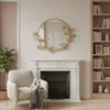 A living room scene with a fireplace, armchair, and bookshelf. Voir les images du produit
