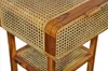 Close-up view of a wooden nightstand with rattan weaving. Produktbild-Vorschau