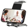 A smartphone displaying a video call between two people is placed on a charging stand. Produktbild-Vorschau
