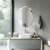 A modern bathroom vanity with a vessel sink and an ornate mirror above it. The scene is set with natural light coming from a large window. Anteprima dell’immagine prodotto