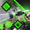 A hand holding a green and black garden hose spray nozzle with a yellow liquid in a clear compartment. The background is blurred greenery. There are graphic overlays with icons and lines. Podgląd zdjęcia produktu