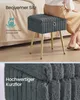 A person is sitting on a gray stool with gold legs next to a bed. A close-up of the stool's fabric is shown below. Produktbild-Vorschau