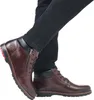 A person wearing black jeans and brown leather boots. Podgląd zdjęcia produktu