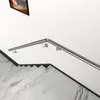 A stainless steel handrail is installed along a white wall next to a marble staircase. Produktbild-Vorschau