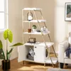 A cat tree with a litter box enclosure is shown in a living room setting. Produktbild-Vorschau