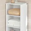 A white bathroom cabinet with open shelves, containing a woven basket and folded towels. Produktbild-Vorschau