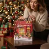 A woman is opening a Christmas advent calendar with makeup products in front of a decorated Christmas tree. Produktbild-Vorschau