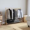 A bedroom scene with a clothing rack and a bed. Anteprima dell’immagine prodotto