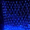 A net of blue lights is draped over a trellis structure in a garden at night. Produktbild-Vorschau