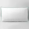 A white pillow with a dark green trim, presented on a plain white background. Produktbild-Vorschau