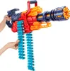 A toy gun with darts is held by two hands against a white background. Produktbild-Vorschau