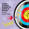 A dartboard with darts, with marketing text overlay. Voir les images du produit