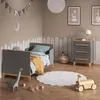 A child's bedroom with a bed, dresser, and toys. Náhled obrázku produktu