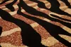 A close-up view of a carpet with a tiger stripe pattern. Produktbild-Vorschau