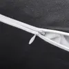 A close-up of a black fabric with a white zipper, showing the texture of the material and the zipper detail. Produktbild-Vorschau