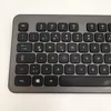 A close-up, top-down view of a dark gray wireless keyboard on a white background. Produktbild-Vorschau