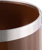 A close-up view of the top rim of a brown cylindrical object with a silver band around the top edge. Produktbild-Vorschau