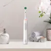 An electric toothbrush and bathroom accessories are displayed on a countertop. Produktbild-Vorschau