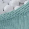 A close-up view of a blue corduroy ball pit with white balls visible in the background. Produktbild-Vorschau