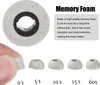 A close-up of a memory foam earbud tip being held by a finger, with other earbud tips lined up below and marketing text about memory foam. Náhled obrázku produktu