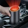 A person's hand holding a car heater in a car's center console. Náhled obrázku produktu