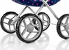 Close-up view of the wheels and frame of a doll stroller. Produktbild-Vorschau