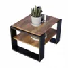A small coffee table with a wooden top and black metal frame, decorated with a potted plant and a small white object. Produktbild-Vorschau
